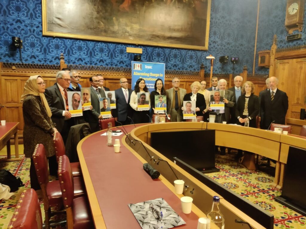 MPs and Lords, as well Iranians hold pictures of political prisoners under the death sentence.
